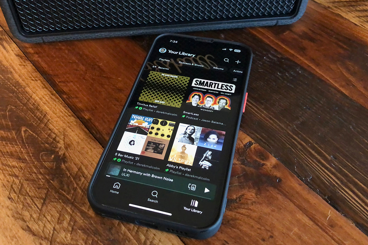 An iPhone with the Home section βof the Spotify app on it.