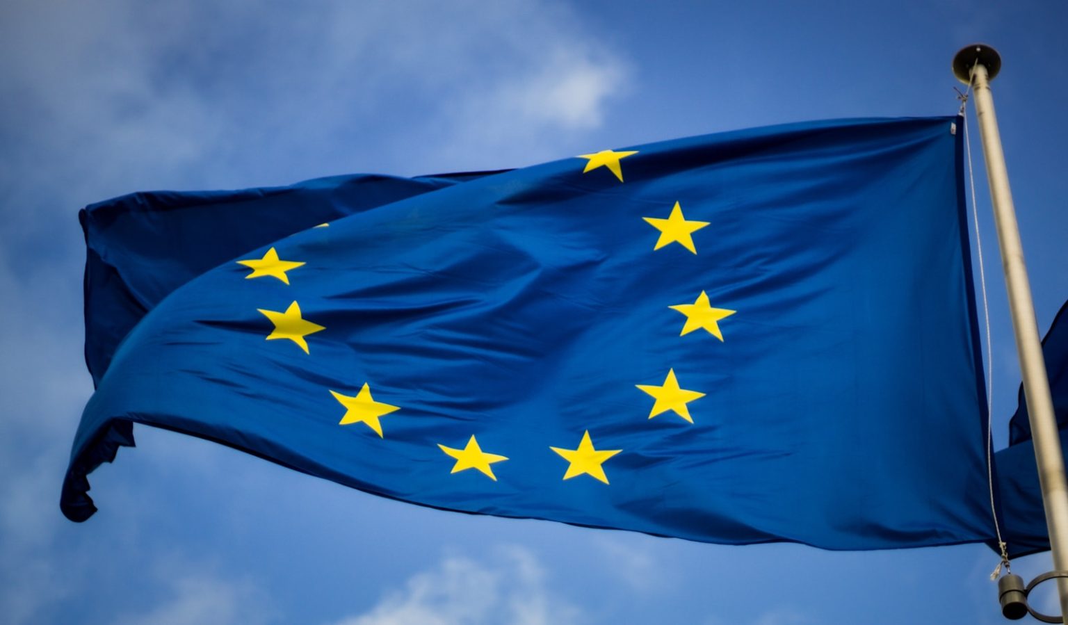 EU AI Act Passes: What’s Next for Artificial Intelligence in Europe blue and yellow star flag