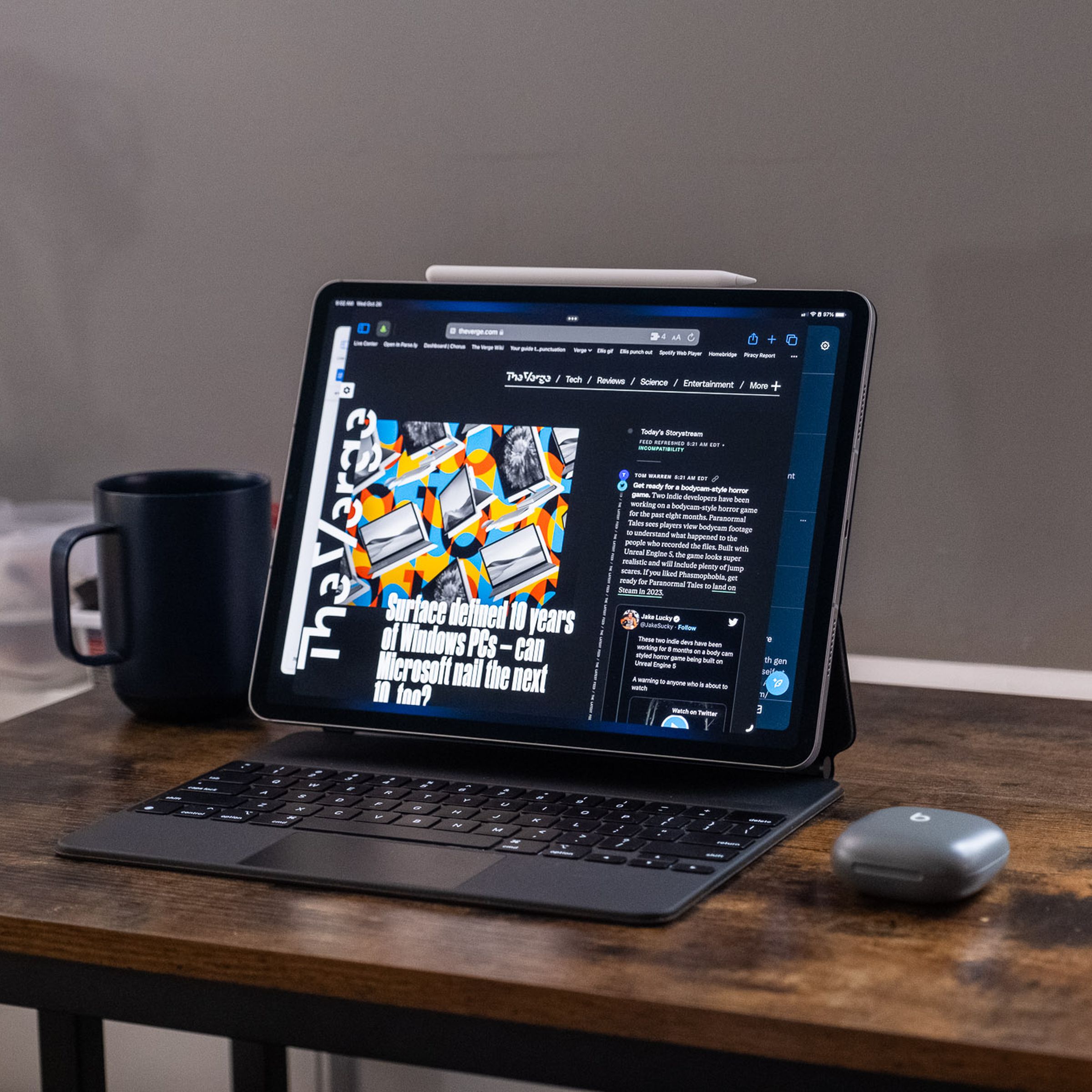 A 2022 Apple iPad Pro in a Magic Keyboard case on a wooden‌ desk.