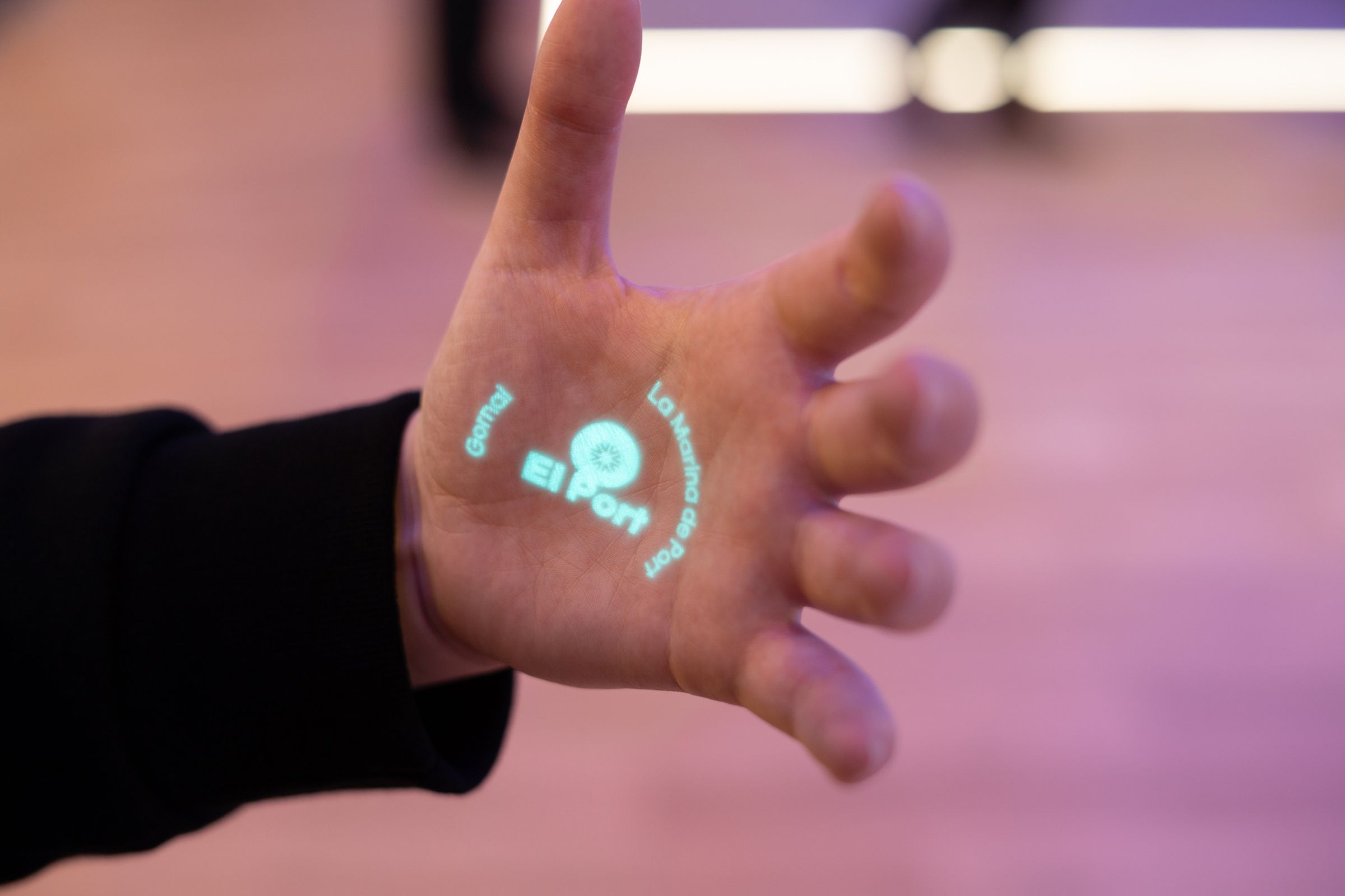 Humane AI pin projecting text onto a person's palm.