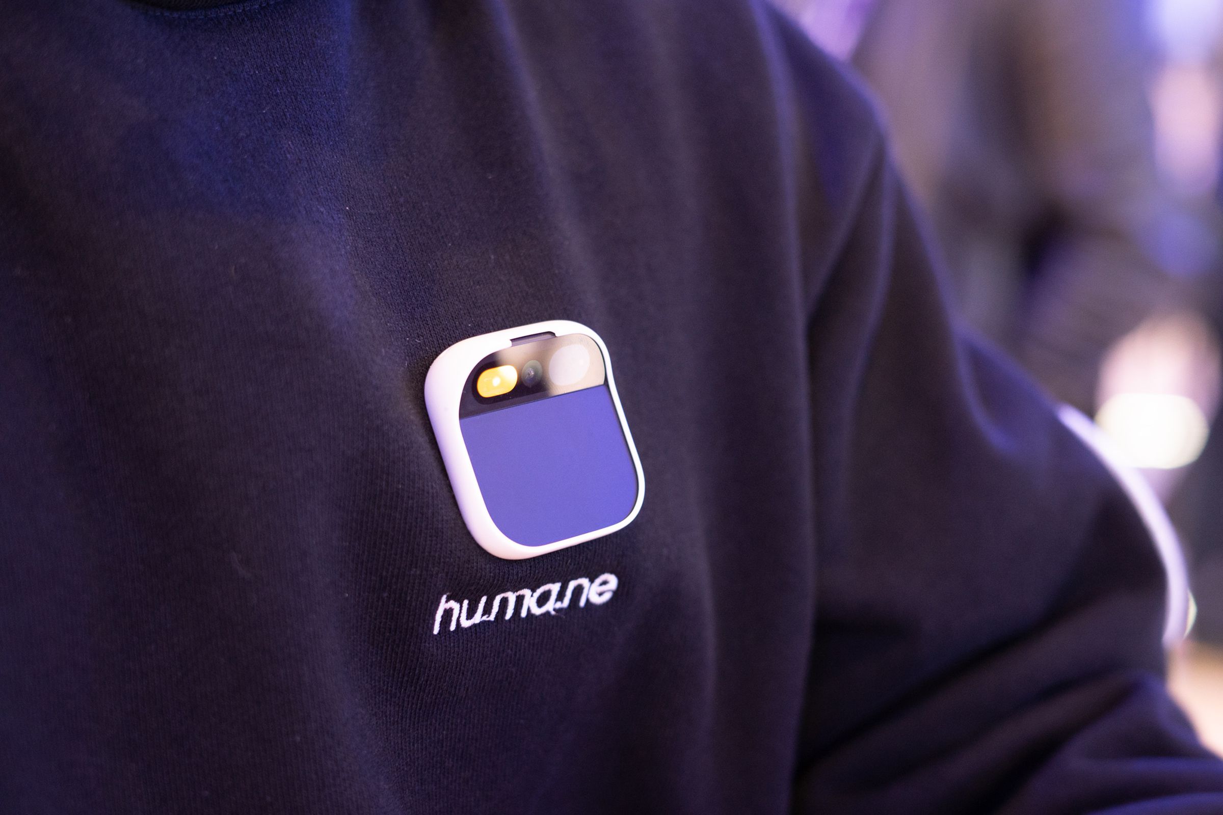 Humane AI pin on a sweatshirt with the Humane logo