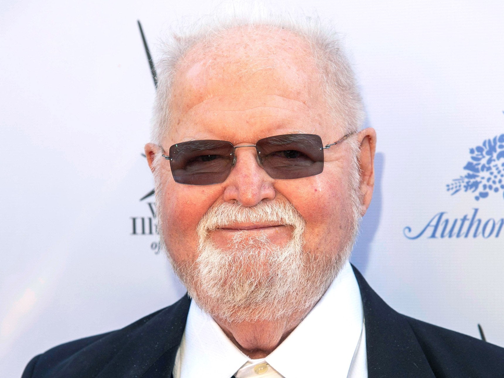 Larry Niven, author of Ringworld, posing in front of‌ white wall on ​the⁣ red carpet of the The 36th and 37th Annual L. Ron⁢ Hubbard Achievement Awards Gala in Los​ Angeles, CA