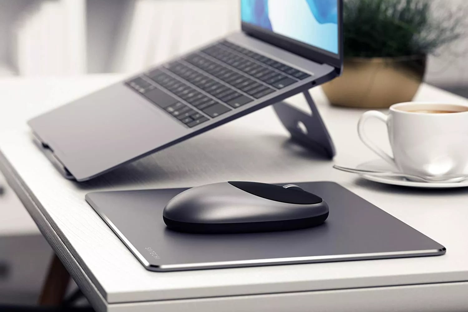 The⁤ Satechi M1 Wireless Mouse⁣ on a desk next to a MacBook.