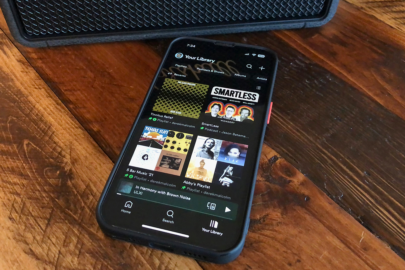 An iPhone with the Home section ​of the Spotify app on it.