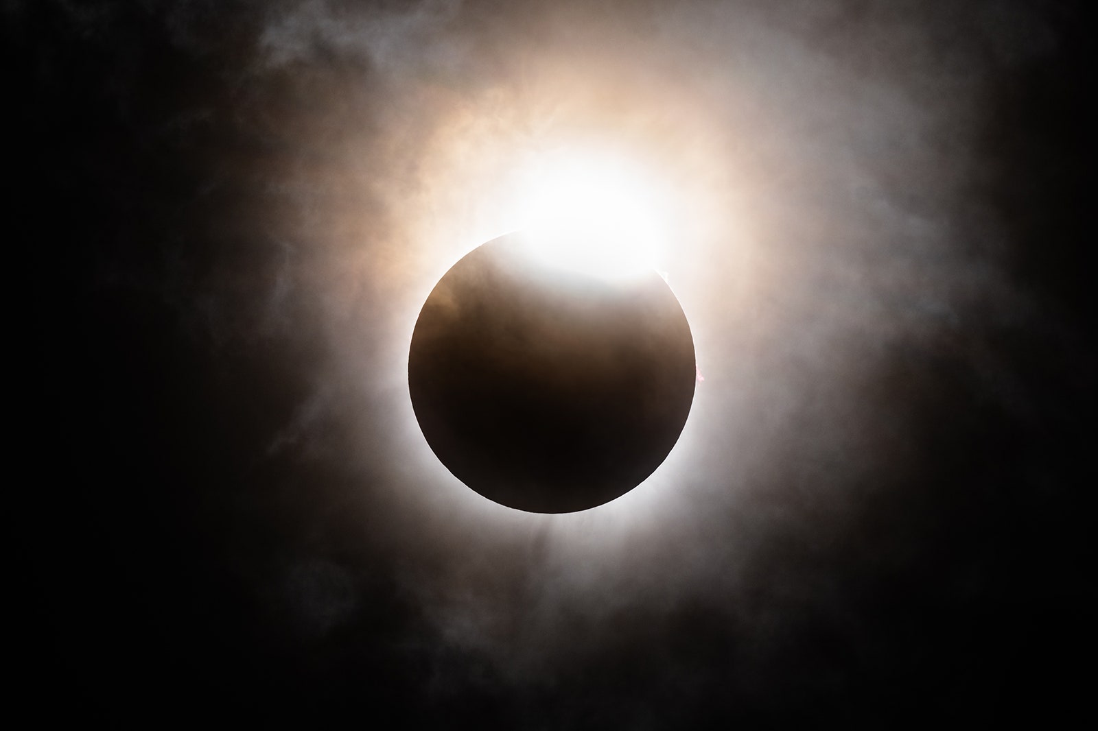 Photo of the moon's descent below the sun's horizon during a total solar eclipse