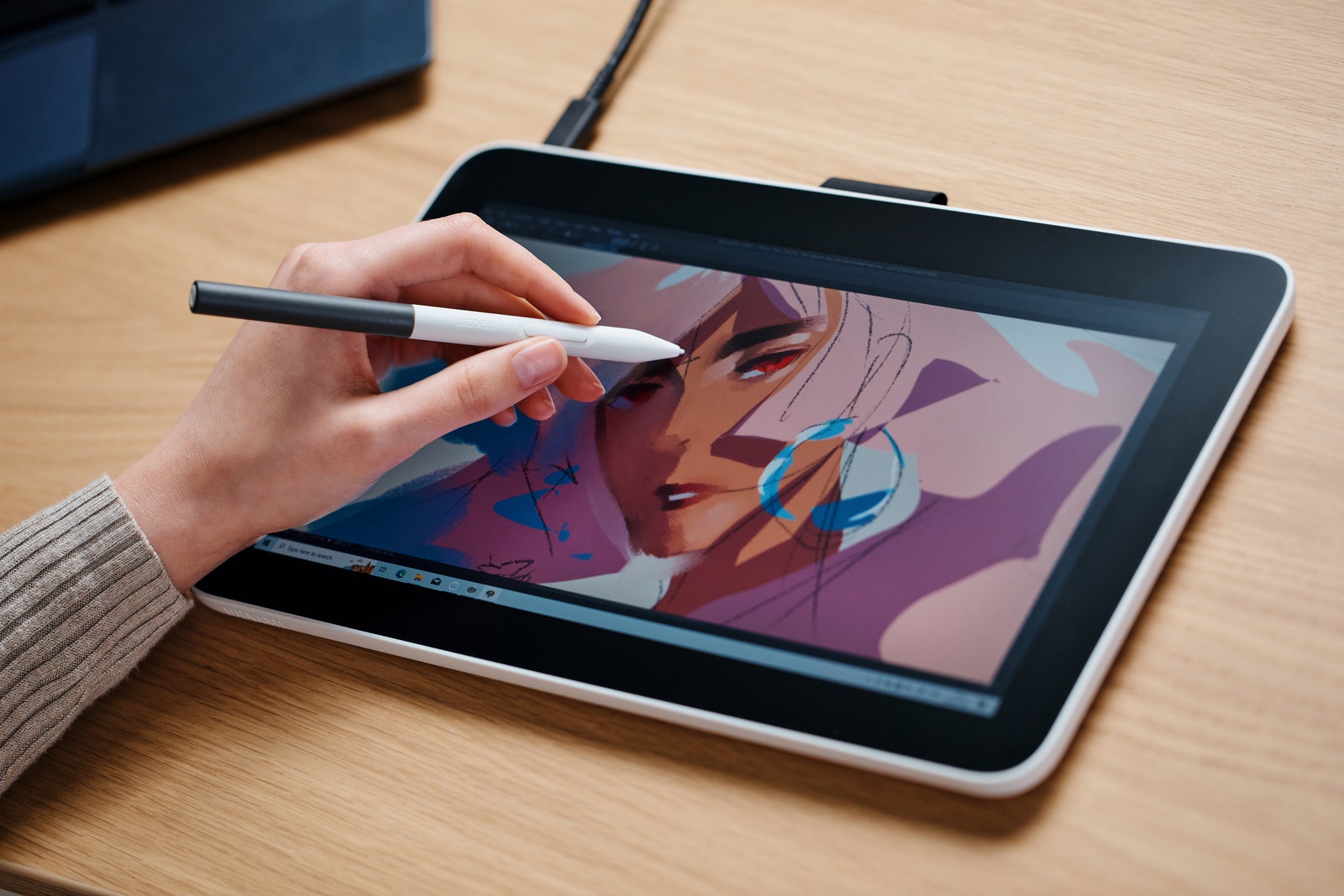 Closeup view of a person drawing on the Wacom One 13 ‌tablet